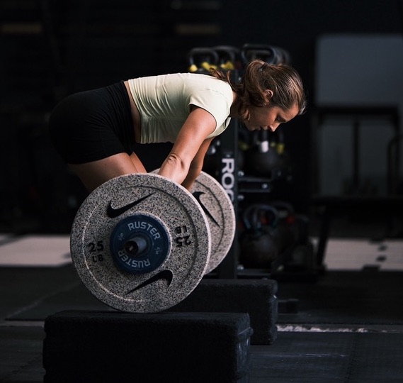 Coach mid-lift in the gym